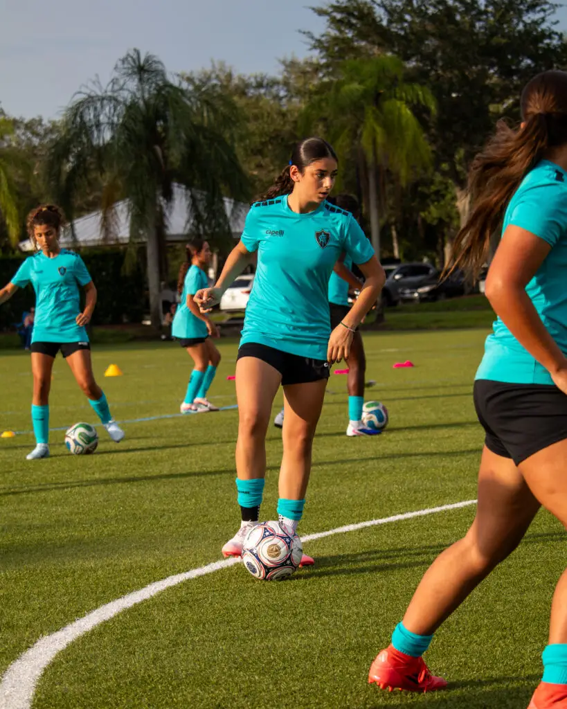 ACF Sunrise player controlling the ball at the center circle during a team training session